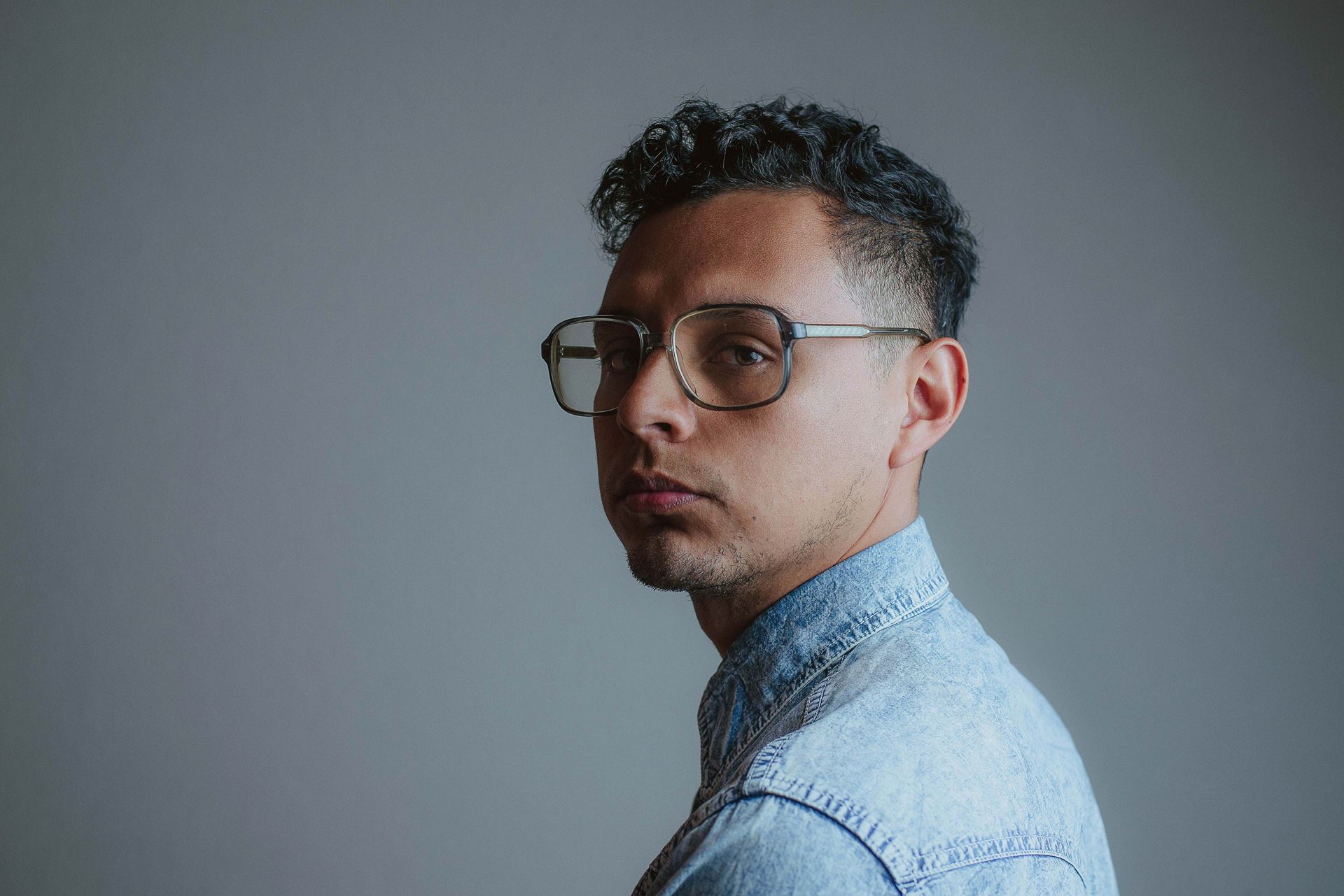 a man wearing glasses and looking at the camera